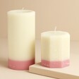 The Recycled Candle Company Pink Jasmine and Pear Octagon Candle with pillar candle against neutral background