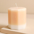 The Recycled Candle Company Blonde Amber and Honey Octagon Candle on top of raised beige surface