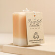The Recycled Candle Company Blonde Amber and Honey Octagon Candle showing label against beige backdrop