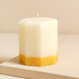 The Recycled Candle Company Ginger and Lime Octagon Candle on top of beige raised surface