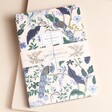 Cream Rifle Paper Co. Set of 3 Peacock Notebooks on top of neutral backdrop