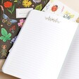 Rifle Paper Co. Set of 3 Curio Notebooks with pink notebook open showing lined pages