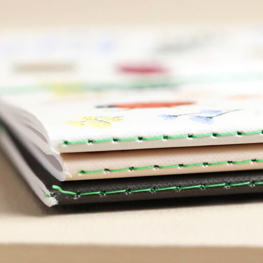 Close up of spines of notebooks stacked together 