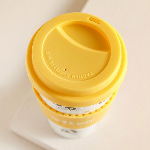 Top of Sass & Belle Bee Travel Coffee Cup against beige background