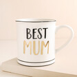 Sass & Belle Best Mum Mug on top of raised beige surface