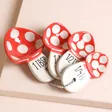 Sass & Belle Mushroom Measuring Spoons against beige coloured backdrop