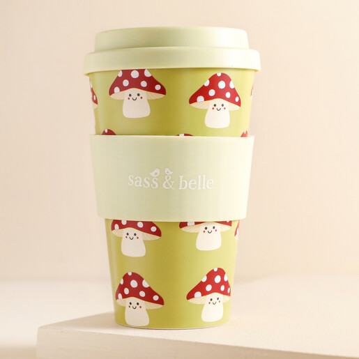 Sass & Belle Mushroom Travel Coffee Cup against beige backdrop