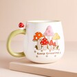 Sass & Belle Retro Keep Growing Mug on top of raised surface with beige backdrop