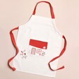 Embroidered House Children's Apron against beige coloured backdrop