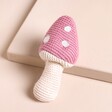 Pink Mushroom Knitted Rattle on Neutral Background