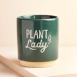 Dark Green Plant Lady Planter on Beige Surface 