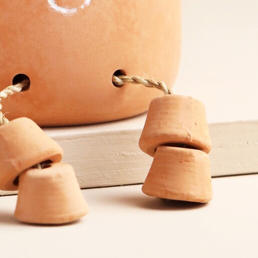 Close Up of If Friends Were Flowers Sitting Planter Feet