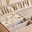 Close up of ring rolls and compartments with jewellery inside of Personalised Large Quilted Velvet Jewellery Box in taupe