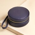 Mini Round Travel Jewellery Case in Navy on top of beige coloured backdrop