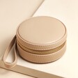 Mini Round Travel Jewellery Case in Mocha closed on top of raised beige surface