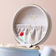 Inside of Personalised Embroidered Flowers Mini Round Velvet Jewellery Case lid against beige coloured backdrop