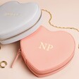 Personalised Heart Travel Jewellery Case in Pink or Grey Against Beige Background