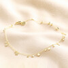 Dainty Flower Charm Anklet in Gold on beige coloured fabric