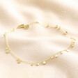 Dainty Flower Charm Anklet in Gold on beige coloured fabric