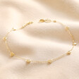 Gold Stainless Steel Tiny Round Heart Charm Anklet on Beige Fabric