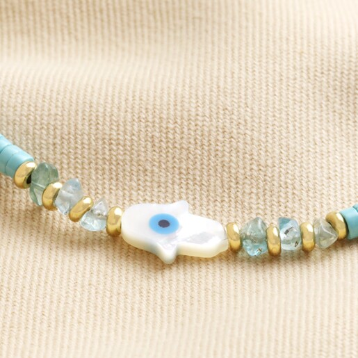 Close Up of Anklet  Close Up of Hamsa Hand Teal Heishi Beaded Anklet in Gold