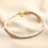 Pink and White Semi-Precious Heishi Beaded Anklet on Beige Fabric