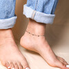 Stainless Steel Heart Charm Anklet on model against beige coloured backdrop