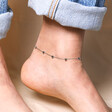 Close up of Stainless Steel Heart Charm Anklet against beige coloured backdrop