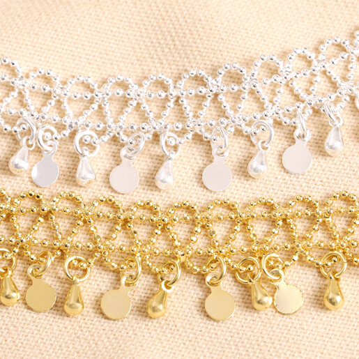 Also Available in Gold Close up of Vintage Effect Chain Anklet in Silver against beige material