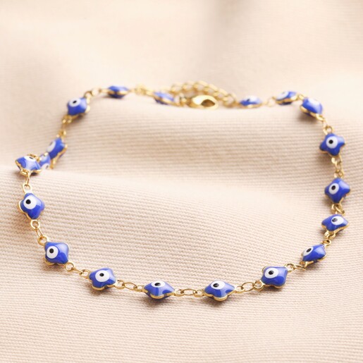 Gold Stainless Steel Blue Enamel Evil Eye Charm Anklet on Beige Fabric