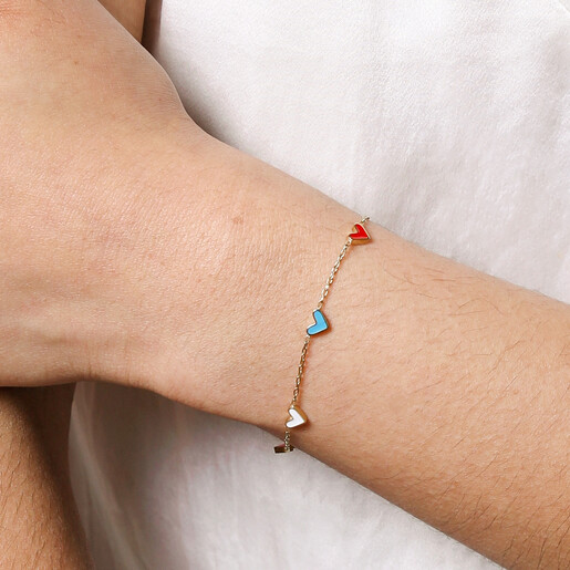 Close Up of Rainbow Enamel Tiny Heart Charm Bracelet in Gold on Model