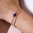Close up of Gold Stainless Steel Blue Stone Double Layered Chain Bracelet on model