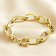 Gold Stainless Steel Chunky Oval Link Chain Bracelet on top of beige coloured fabric