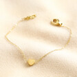 Gold Stainless Steel Tiny Round Heart Charm Bracelet on Beige Fabric