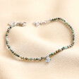 Heart Crystal Charm Semi-Precious Stone Beaded Bracelet on top of beige coloured fabric