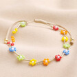 Colourful Daisy Beaded Cord Bracelet on top of beige coloured fabric