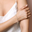 Pastel Semi-Precious Stone Beaded Bracelet in Gold on model with hand on arm in front of beige backdrop
