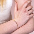 Model Wearing Rose Quartz Charm Chain Bracelet in Gold