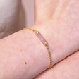 Close Up of Model Wearing Rose Quartz Charm Chain Bracelet in Gold