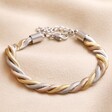 Mixed Metal Stainless Steel Chunky Triple Snake Chain Bracelet on top of beige coloured fabric