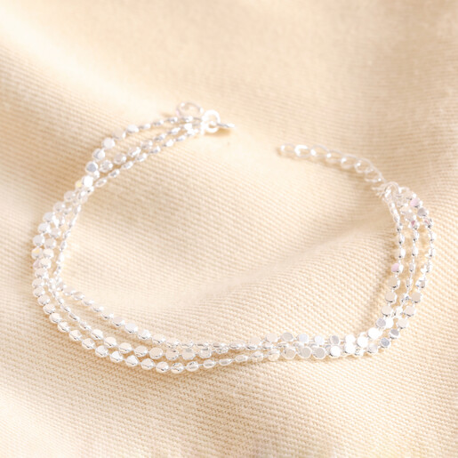 Triple Layered Dotted Chain Bracelet in Silver Triple Layered Dotted Chain Bracelet in Silver on Beige Fabric