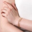 Triple Layered Dotted Chain Bracelet in Gold on model with hand on arm