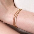 Triple Layered Dotted Chain Bracelet in Gold on model with hand on arm