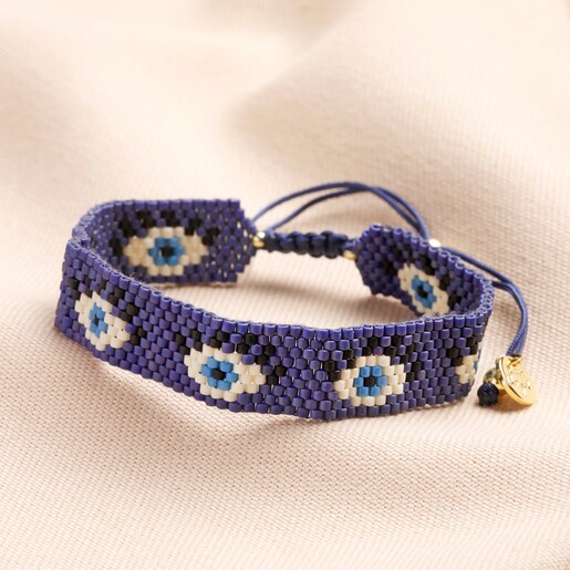 Navy Evil Eye Beaded Woven Cord Bracelet on Pink Fabric