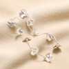 Flower Petal Drop Earrings in Silver on model against beige coloured fabric