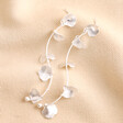 Flower Petal Drop Earrings in Silver against beige fabric