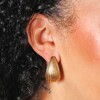 Close up of Gold Stainless Steel Ridged Teardrop Half Hoop Earrings 