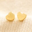 Gold Stainless Steel Tiny Round Heart Stud Earrings on Beige Fabric