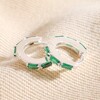 Green Baguette Crystal Huggie Hoop Earrings in Silver on Beige Fabric