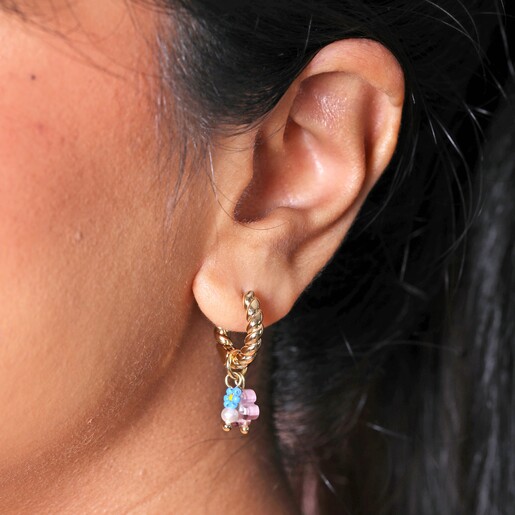 Earrings on Model Close up of Millefiori Flower Bead Twisted Drop Huggie Hoop Earrings in Gold on model